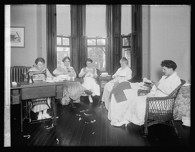 Five members of the American Red Cross College Women's Club sitting and sewing.